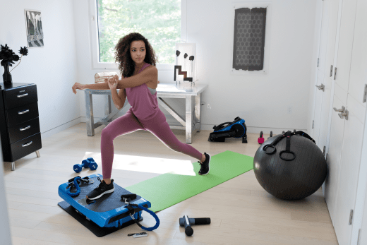 A Woman exercising while using a vibration plate