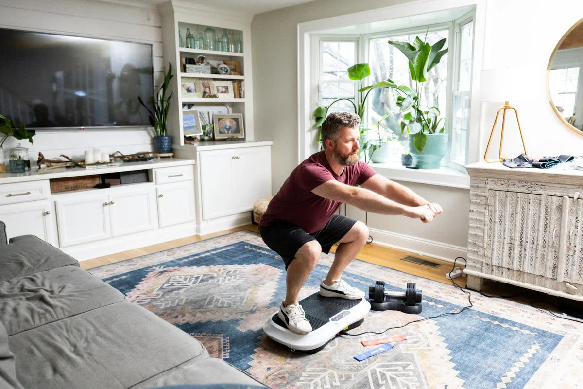 Man doing squats on the vibration plate