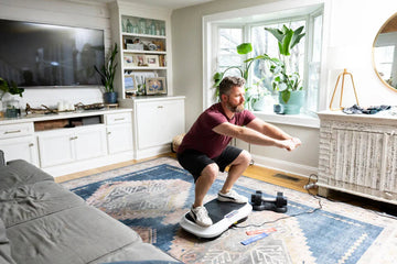 Man doing squats on the vibration plate