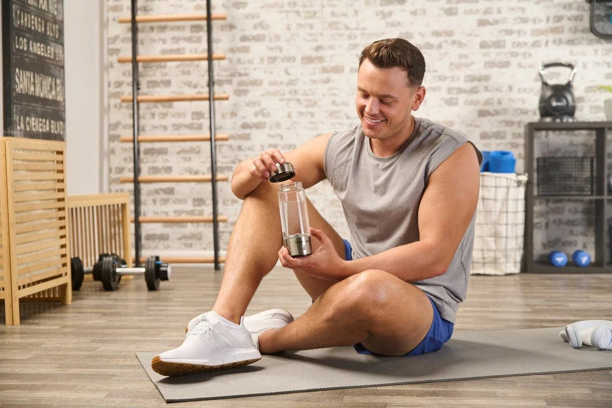Man holding a hydrogen water bottle