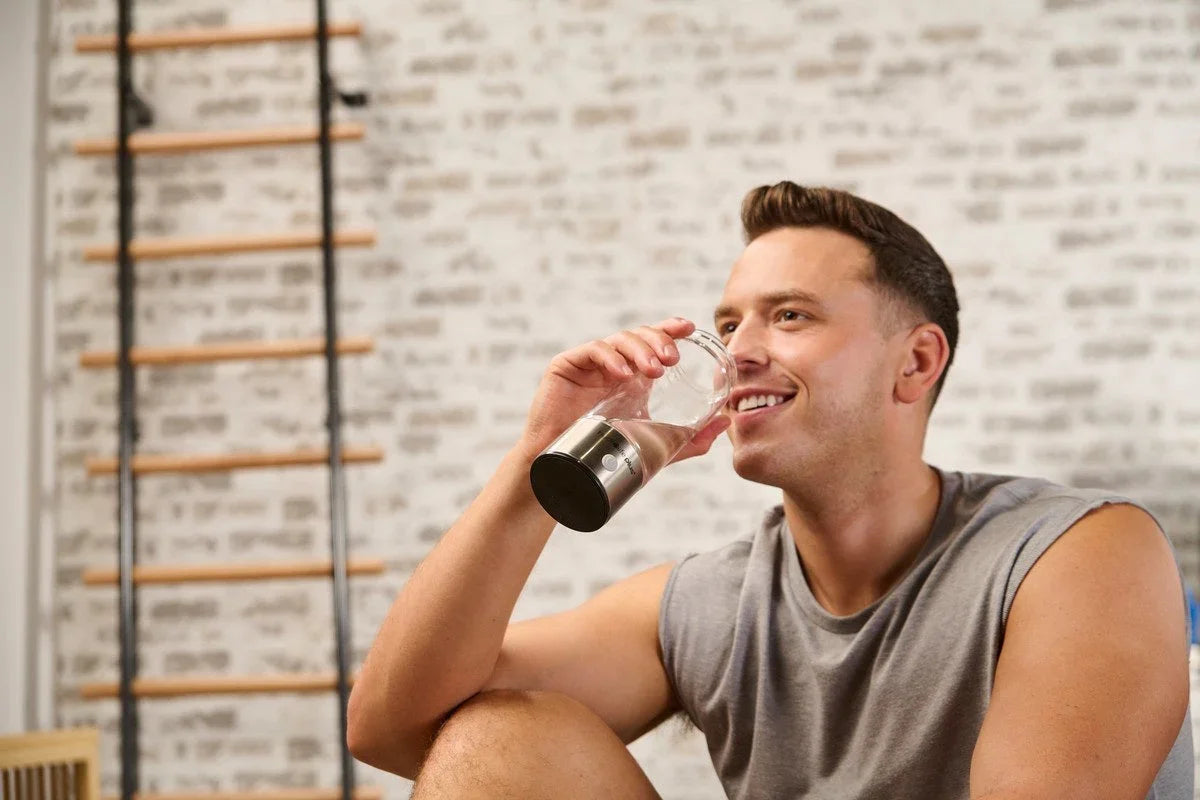 Man drinking from a hydrogen water bottle