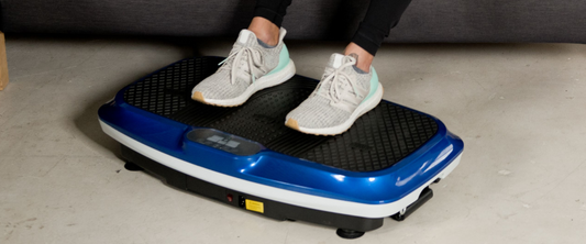 Man exercise on a vibration plate and woman running on a treadmill - home gym