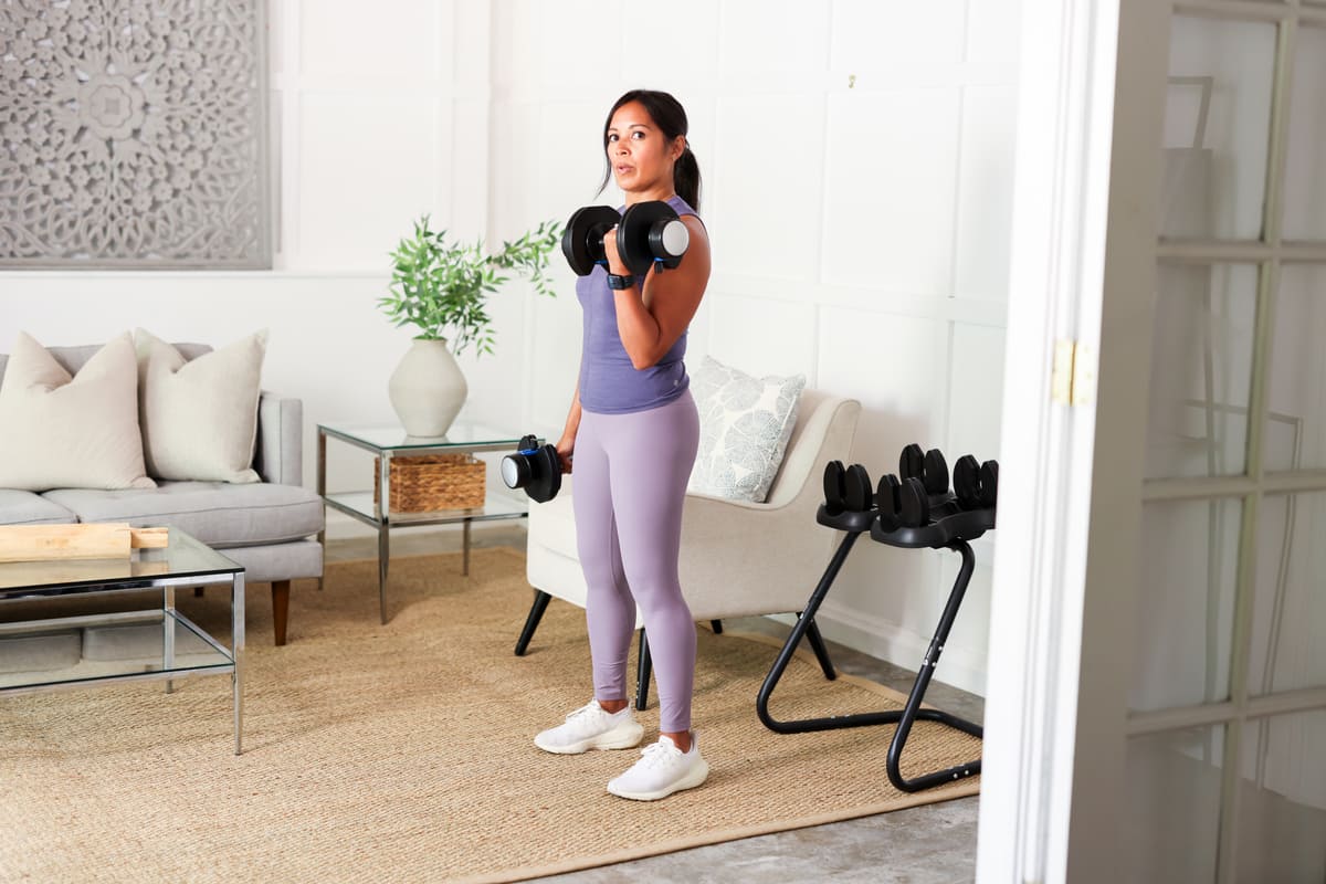 Woman using adjustable dumbmbells