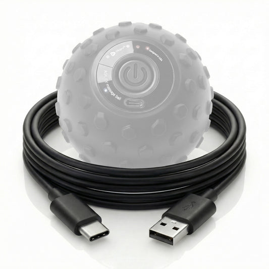 Black USB cable coiled next to a gray massage ball on a white background