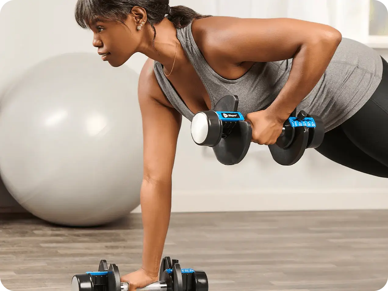 Woman doing dumbbell push-ups with Lifepro adjustable dumbbells — HSA and FSA eligible fitness equipment for home workouts